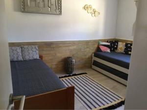 a bedroom with two beds and a rug at Quinta Vale de Luz in Silves