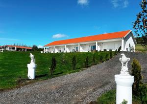 a building with a road with statues in front of it at Killeröd Boutique Apartments in Båstad