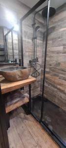 a bathroom with a stone sink on a wooden table at Chez Rémy in Les Angles