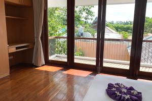 a room with a balcony with a large window at Farmers Villa CoLiving Space in Mae Nam