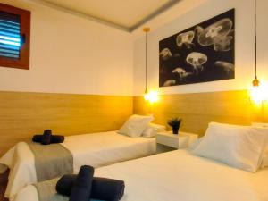 une chambre d'hôtel avec 2 lits et une chambre avec des crânes sur le mur dans l'établissement Stylish Friendly Holiday Home, à Playa del Ingles