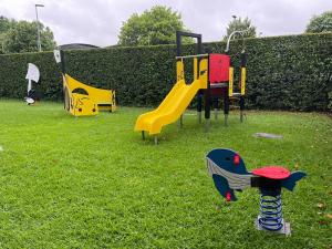 a group of playground equipment in the grass at Hotel do Parque in Viana do Castelo