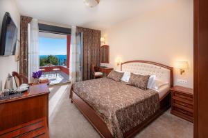 a hotel room with a bed and a balcony at Hotel Cvita in Split