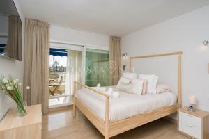 um quarto com uma cama e uma grande janela em Benalmadena Costa Sol Holiday Rentals em Benalmádena
