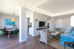 a living room with a blue couch and a table at Genteel Home Elcano Terrace in Málaga