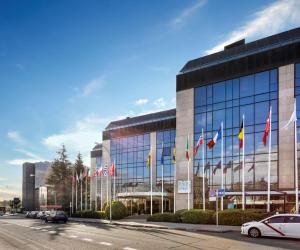 a building with a bunch of flags in front of it at Melia Avenida de America in Madrid