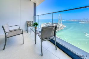a balcony with chairs and a view of the ocean at Luxury 3BR with Assistants Room at The Address Residences in JBR by Deluxe Holiday Homes in Dubai