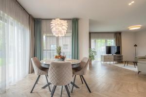 a dining room with a table and chairs at Vila „Perkūnas“ in Palanga