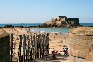 a group of people on a beach near the ocean at Le Bigorneau , beach at 20m and free private carpark in Saint Malo