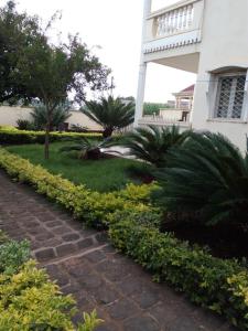 a brick path in front of a house at MANOIR DES PRINCESSES BAFOUSSAM in Bafoussam