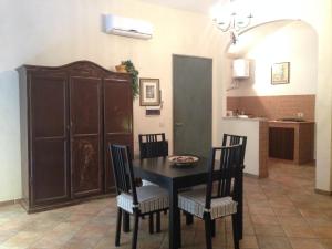 comedor con mesa y sillas y cocina en Casa Dodo, en Nápoles
