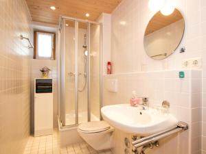 a bathroom with a toilet and a sink and a shower at Landhaus Albrecht in Mittenwald +37 photos