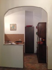 a kitchen with a counter and a refrigerator in a room at Casa Dodo in Naples