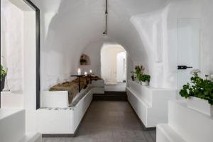 a white hallway with a bed and a table at Hotell Skeppsbron in Stockholm