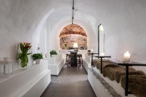 a room with white walls and tables with fur covered seats at Hotell Skeppsbron in Stockholm