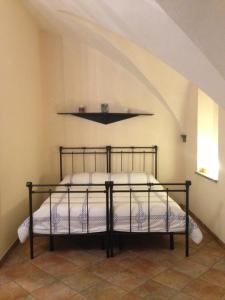 a bedroom with a bed with a black metal frame at Casa Dodo in Naples