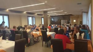 a group of people sitting at tables in a room at Hostal Rural San Andrés in Torres del Río