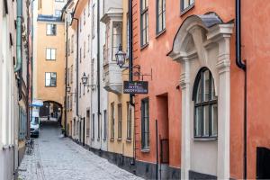 an empty alley in a city with buildings at Hotell Skeppsbron in Stockholm