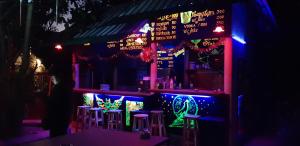 a bar with purple and green lights on it at Peace of Love Pai in Pai +107 photos