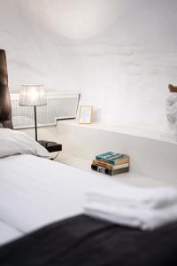 a bedroom with a bed with a lamp and books at Hotell Skeppsbron in Stockholm