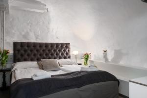 a bedroom with a large bed with a black headboard at Hotell Skeppsbron in Stockholm