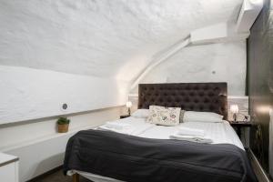 a bedroom with a large bed with white walls at Hotell Skeppsbron in Stockholm