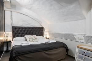 a bedroom with a large bed with a large window at Hotell Skeppsbron in Stockholm