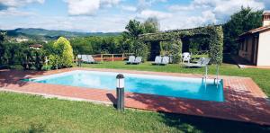 a swimming pool in the yard of a house at Villa Paola in Arezzo