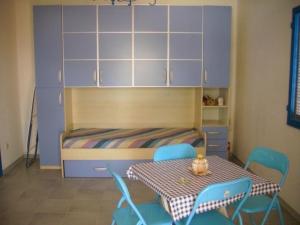 1 dormitorio con 1 cama, mesa y sillas en Holiday home Riserva Marina Protetta, en Siracusa