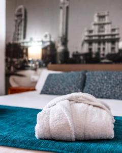 a white towel sitting on top of a bed at Hotel Adonis Plaza in Santa Cruz de Tenerife