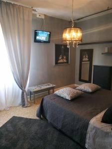 a bedroom with two beds and a tv on the wall at Spazio d'arte 372- Three rooms -near the center and train station in Modena