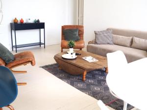 a living room with a couch and a coffee table at Le Bigorneau , beach at 20m and free private carpark in Saint Malo
