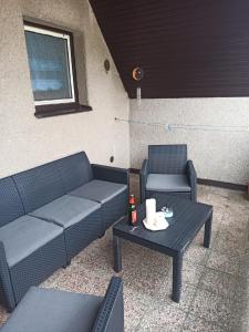 a patio with two couches and a coffee table at apartman Luník in Svratka