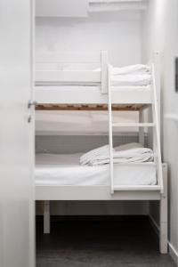 two white bunk beds in a room at Hotell Skeppsbron in Stockholm