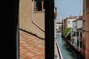 a view of a canal from a window at Palazzetto Barnaba in Venice