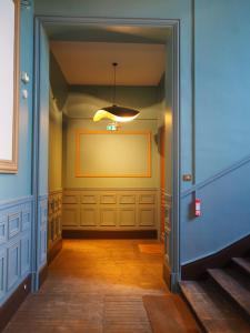 a hallway with a yellow wall in a room at Le Bigorneau , beach at 20m and free private carpark in Saint Malo