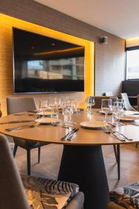 a table in a restaurant with glasses on it at Hotel Adonis Plaza in Santa Cruz de Tenerife