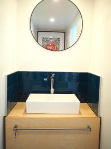 a bathroom with a white sink and a mirror at Le Bigorneau , beach at 20m and free private carpark in Saint Malo