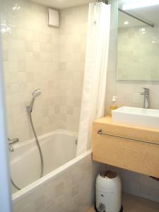 a bathroom with a tub and a sink at Le Bigorneau , beach at 20m and free private carpark in Saint Malo +21 photos