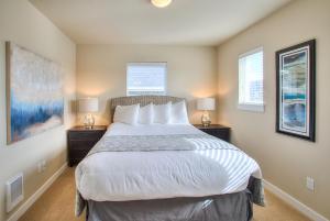 a bedroom with a large bed with two night stands at Crabby Daddy The Blue Mermaid in Ocean Shores
