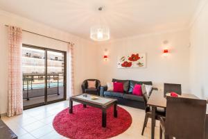 a living room with a couch and a table at Vandalou By ALzira in Albufeira