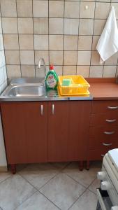 a kitchen counter with a sink and a cleaning kit at ORO BIANCO in Marsala