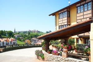 a building with potted plants and flowers on it at La Solana Montañesa in Comillas