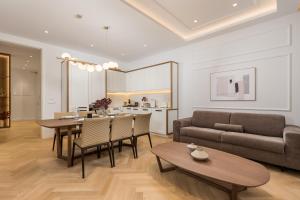 a living room with a table and a couch at Plaza Apartments in Opatija