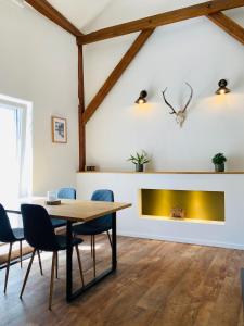 a dining room with a table and a fireplace at Alte Scheune in Werneck +6 photos