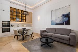 a living room with a couch and a table at Plaza Apartments in Opatija