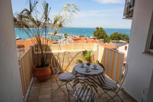 a balcony with a table and chairs and a view of the ocean at Apartma Srčanka in Koper