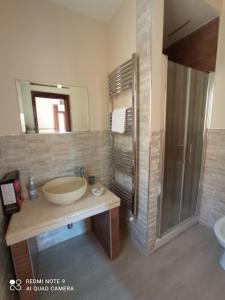 a bathroom with a large sink and a shower at La sinfonia di.kerkent in Agrigento +18 photos