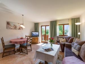 a living room with a couch and a table at Gästehaus Gerti in Kiefersfelden