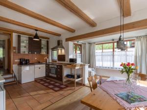 a kitchen and living room with a table and a dining room at Gästehaus Gerti in Kiefersfelden